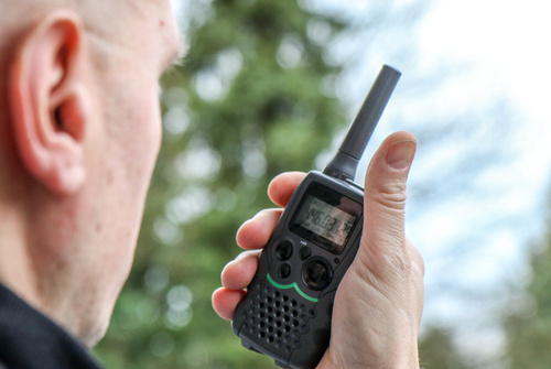 security officer reporting on walkie talkie